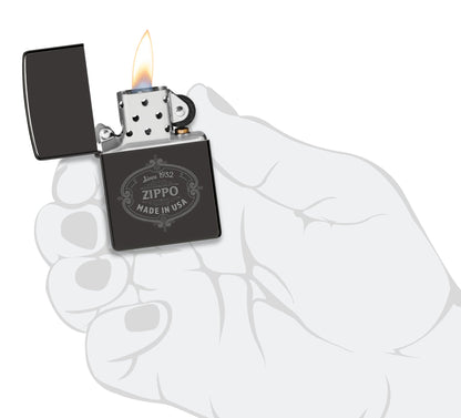 Zippo Plaque Design High Polish Black Windproof Lighter lit in hand.